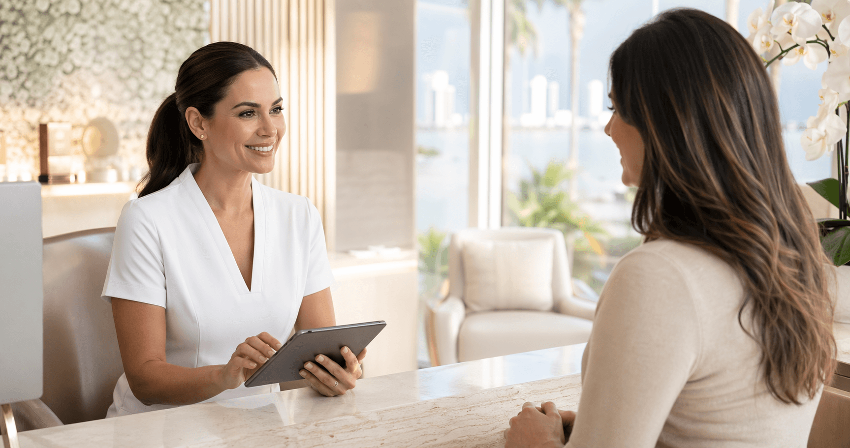 Med-spa professional assisting a client inside an elegant consultation space in Miami.