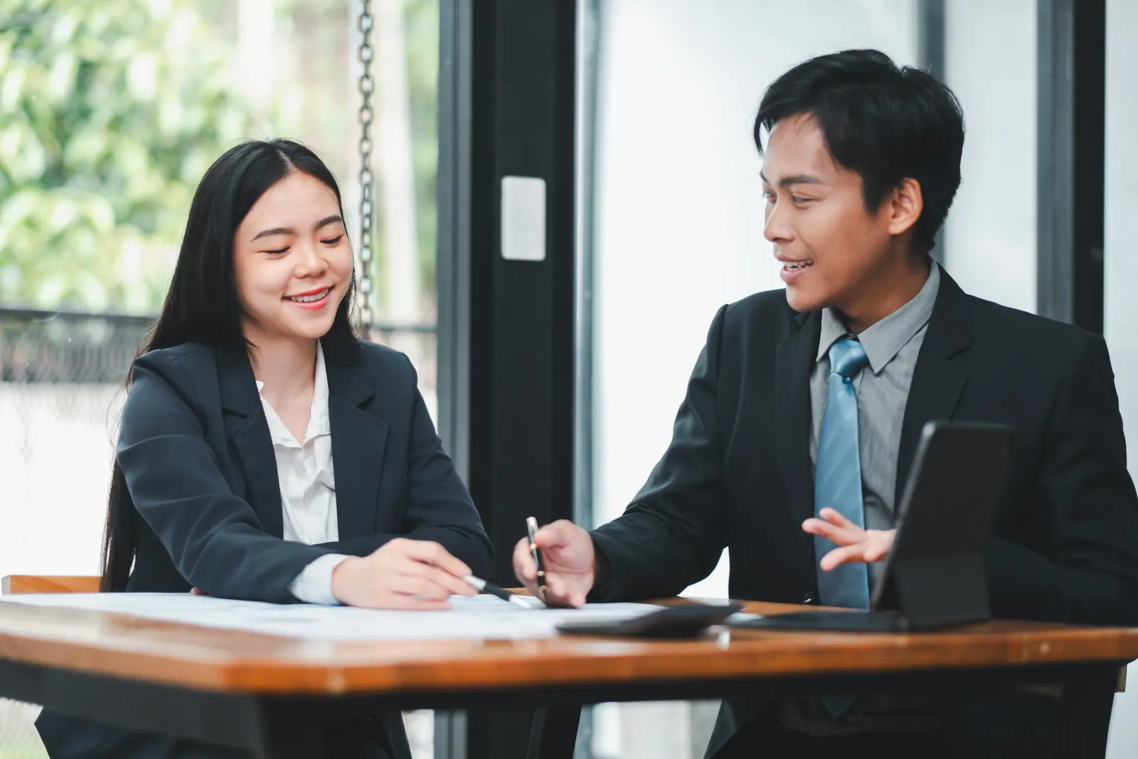 Two people reviewing numbers and a budget during a business consultation.